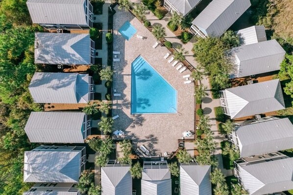 An aerial view of a hotel with multiple buildings, a central swimming pool, and surrounding palm trees. - Cozy Bay-View 2BR/2.5 Bath in Port St. Joe with Pool & Beach (Port St. Joe)