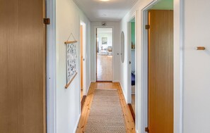 A hallway with wooden flooring, white walls, and a door on the right. - Gorgeous home in Stubbekøbing with WiFi (Stubbekøbing)