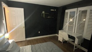 A bedroom with a bed, a desk, and a chair. - 1-bedroom townhome in Odenton with guest share bath. (Odenton)