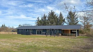 A two-story building with a dark roof and large windows. - Nice home in Oksbøl with WiFi (Oksbøl)