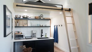 A modern kitchen with a built-in dishwasher, a coffee machine, and a toaster.