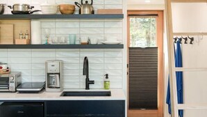 A compact kitchen with modern appliances, a built-in oven, and a sink.
