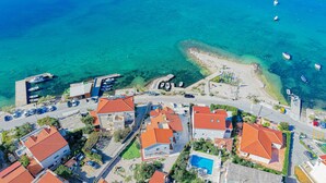 An aerial view of a coastal residential area with houses, a swimming pool, and boats in the water. - Luxury Beach Villa, Sibenik, 4 Stars (Brodarica)