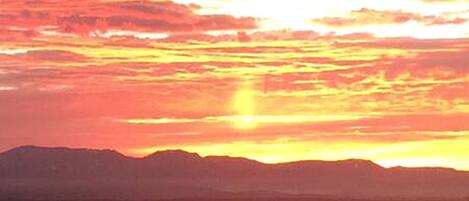 A sunset over a mountainous landscape.