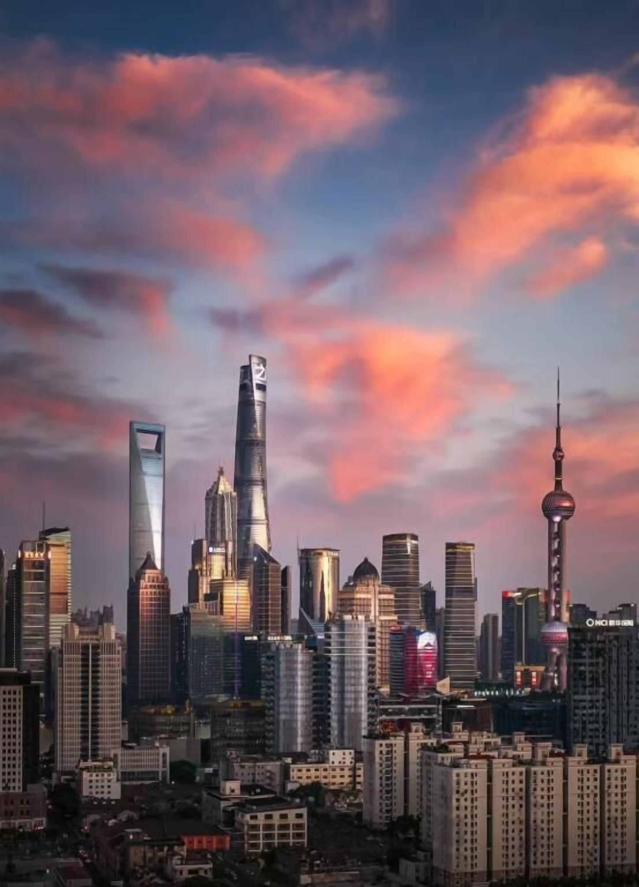 A city skyline with modern high-rise buildings, including a distinctive tower with a spherical observation deck.