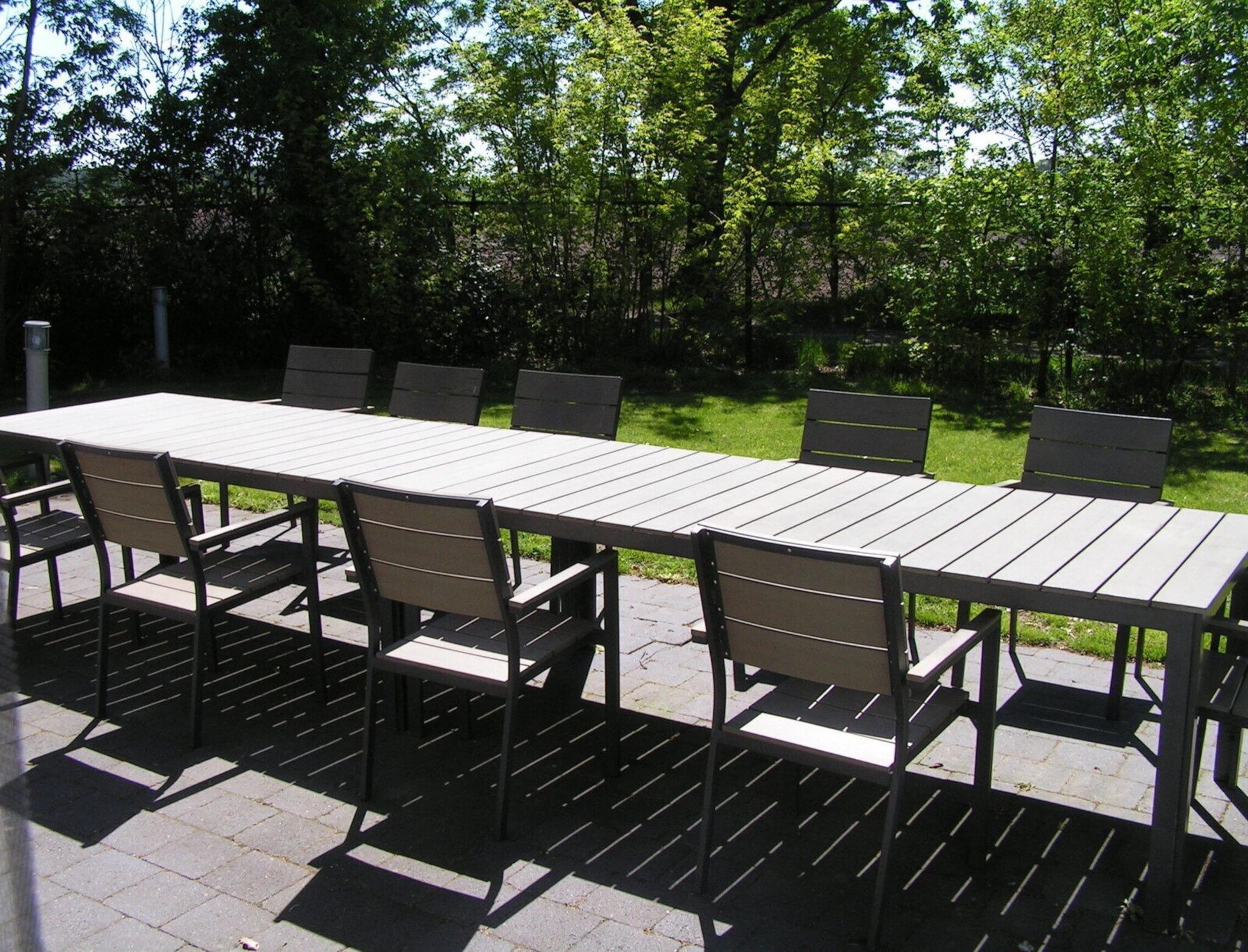 An outdoor patio with a rectangular table and six chairs.