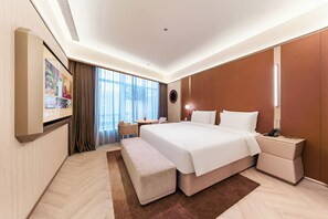 A modern hotel room with a large bed, a desk, a chair, a small table, and a large window. - Orange Crystal Shanghai Jinqiao (Shanghai)