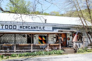 A rustic building with a sign reading 'TODD MERCANTILE' and a 'BAKERY' sign above the entrance.