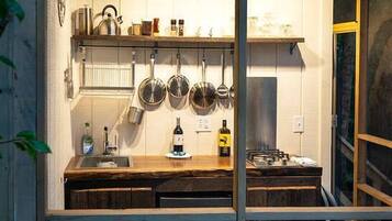 Coffee/tea maker, fridge, stovetop, cookware/dishes/utensils