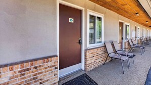 A row of hotel rooms with a brick base and a wooden ceiling. - Eagle Motel Suite 105 (Manitou Springs)