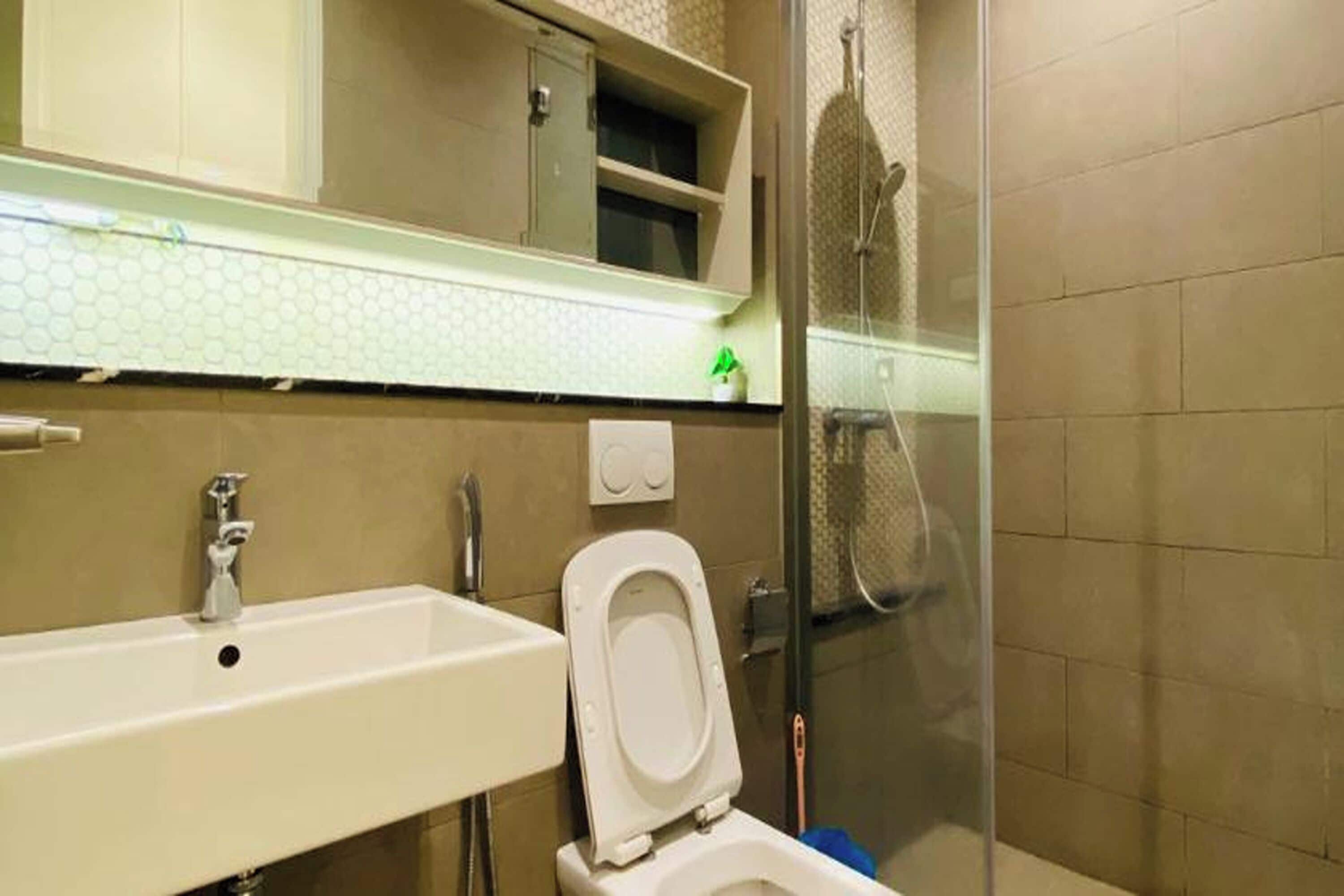 A bathroom with a sink, toilet, and shower.