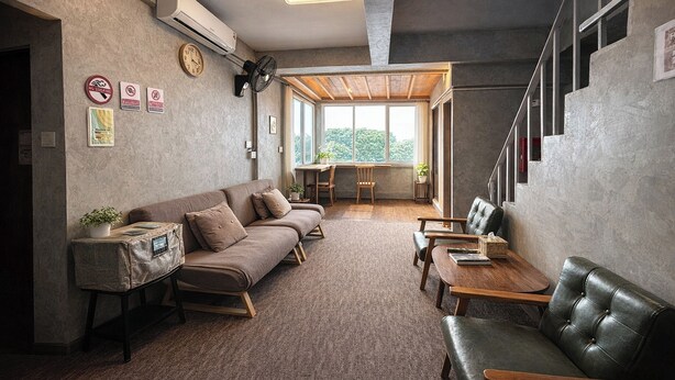 A modern interior with a sofa, a dining table, and a staircase. - Nonoteru Chiang Mai Kamphaeng Din (Chiang Mai)