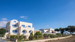 A multi-story building with balconies, arched windows, and a white facade. - Apartment Sea View BB 3 guests in a family hotel (Perivolos)