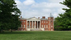 A large, red brick building with a central portico and a dome. - Central Studio in the Heart of Hounslow! (Greater London)
