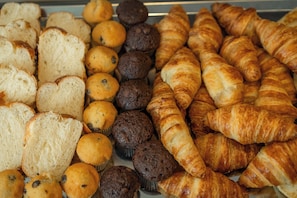 A variety of baked goods including bread, muffins, and croissants. - Muselet Adults Only (Świnoujście)