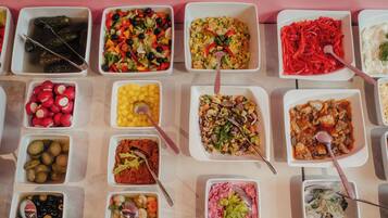 A variety of food dishes arranged in square containers.