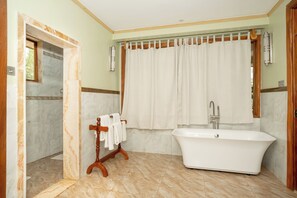 Deluxe Single Room, Partial Lake View | Bathroom | Combined shower/tub, hair dryer, slippers, towels