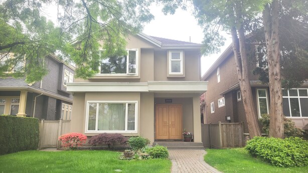 A two-story house with a front door, a large window, and a brick pathway leading to the entrance. - Sunshine Home Vancouver Near UBC/DT/YVR  Family-sized Studio (Vancouver)