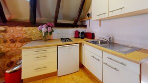 A compact kitchen with a dishwasher, a gas stove, a sink, and a small countertop. - The Shepherd's House at Domaine des Fargues **** (Sainte-Foy-de-Longas)