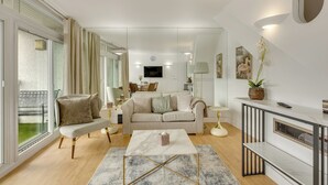 A modern living room with a sofa, coffee table, and a fireplace. - LuxeLet St Giles Duplex Penthouse  (London)