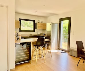 A modern kitchen with a wooden countertop, a built-in dishwasher, and a large window. - Le Refuge de Souspierre - Calm & disconnection (Souspierre)