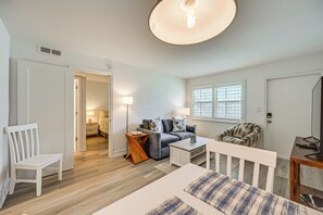 A modern living room with a sofa, coffee table, and a TV stand. - Poolside Fun, Ocean Strolls! Naples Beach Getaway (Naples)