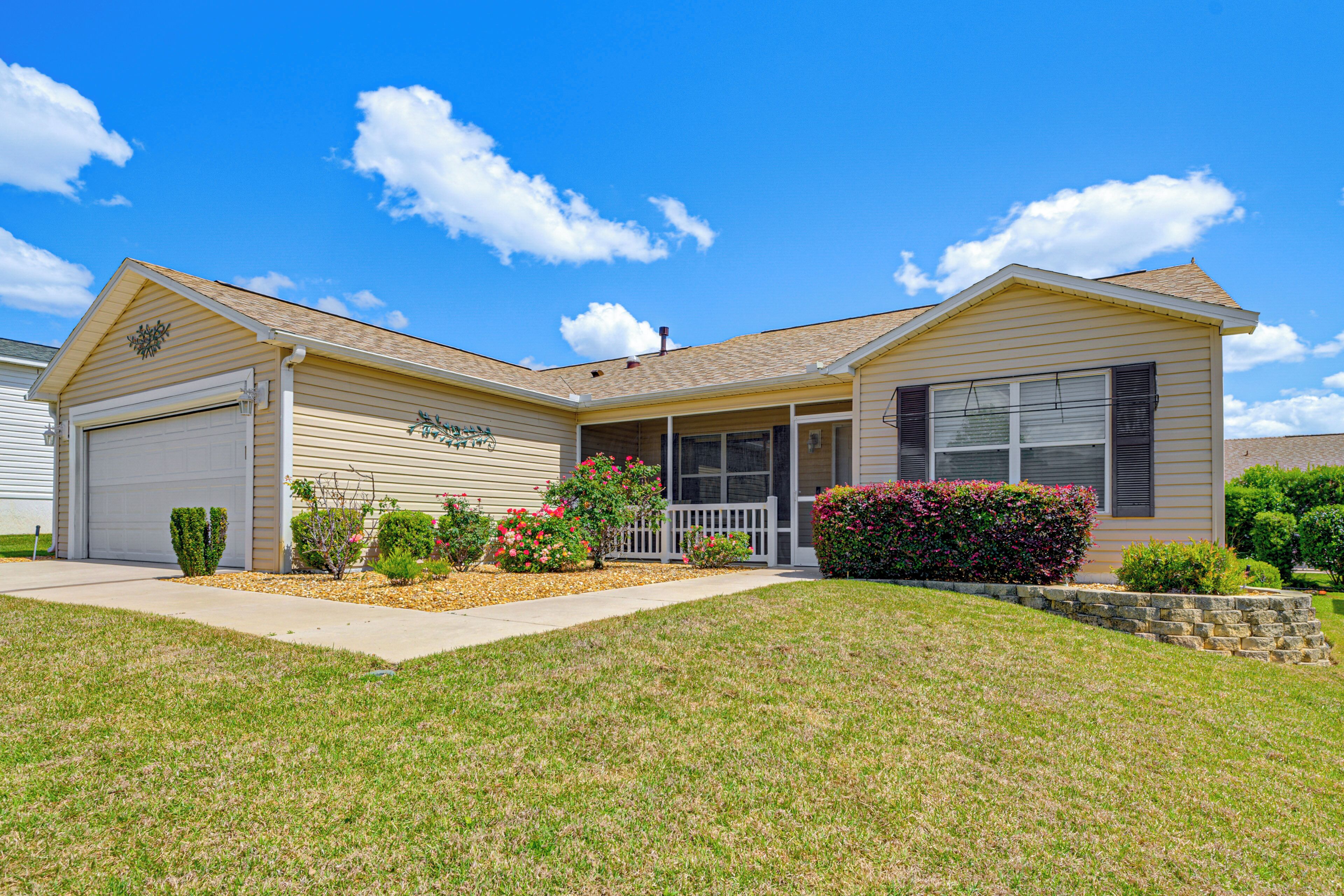 A single-story house with a garage, a front porch, and a well-maintained lawn.