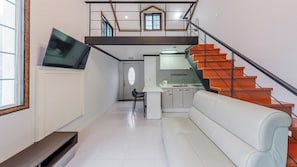 A modern interior with a staircase, a kitchen area, and a seating area. - Gapyeong Hue 910 Pension (Gapyeong)
