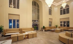 A spacious lobby with high ceilings, large windows, and multiple seating areas. - Sawarthia Sewa Sadan Ayodhya (Faizabad)