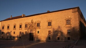 A large, historic building with a symmetrical facade, multiple windows, and a central entrance. - Castilla Termal Palacio de Avellaneda  (Penaranda de Duero)