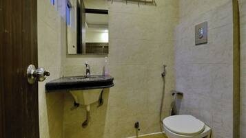 Deluxe Room | Bathroom | Shower, towels, soap, toilet paper