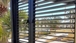 A building with a black metal gate and a beige wall. - Casa Zimbo in Costa Calma (Pajara)