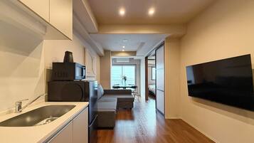 Junior Apartment | Living area | 55-inch Smart TV with cable channels