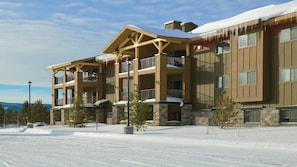 A multi-story hotel with a snow-covered roof and balconies.
