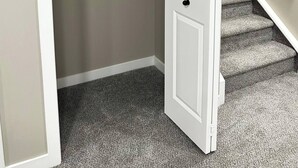 A closet with a hanging rod, a folded towel, and a bottle. - Private, Cozy, Luxury, Spacious One Bedroom Suite (Airdrie)