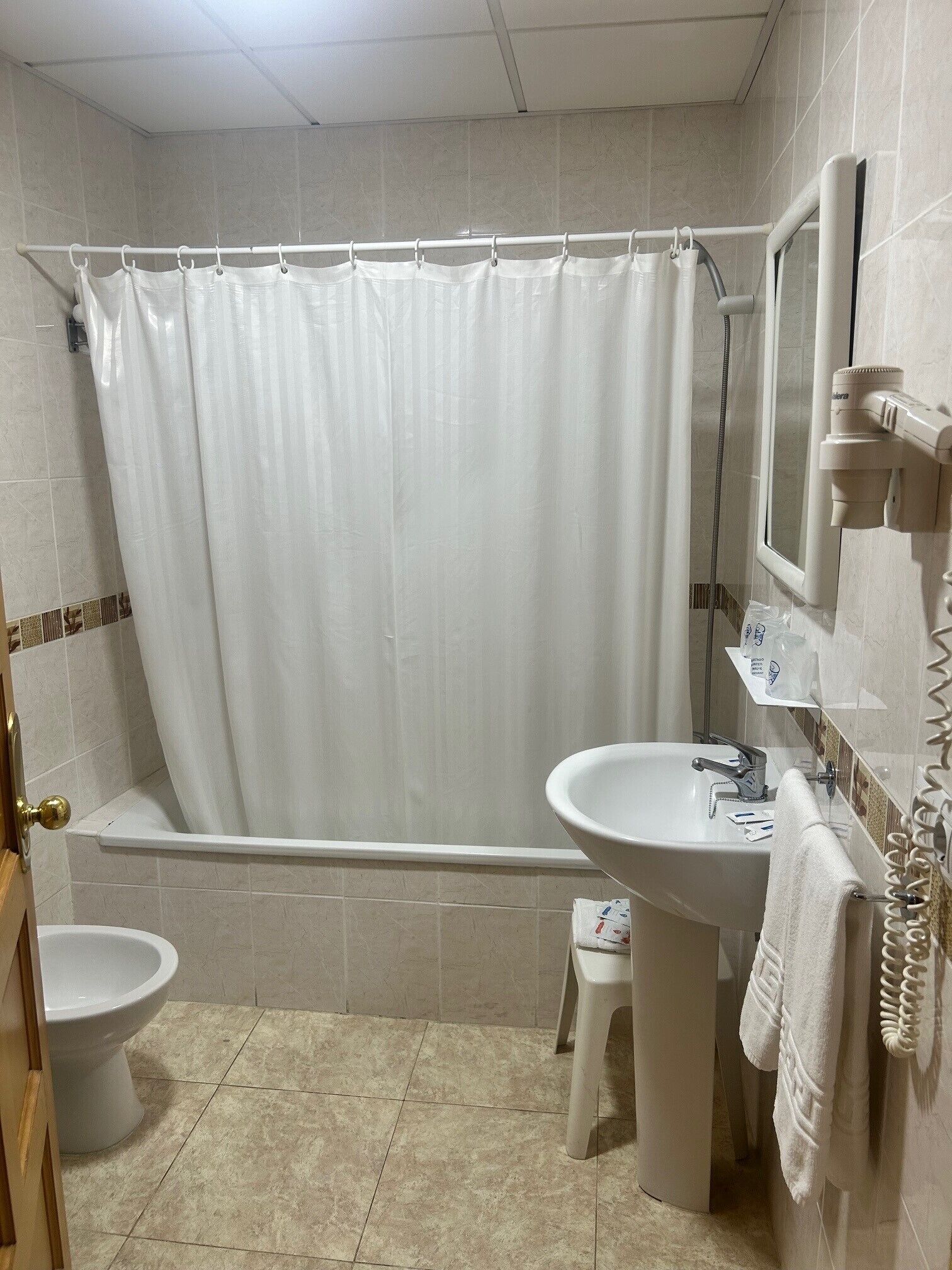 A bathroom with a bathtub, toilet, and sink.