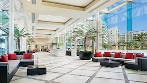 A spacious lobby with modern furniture, large windows, and indoor plants. - Ocean-View 2BR Villa at Westin Lagunamar – Cancún Beachfront Pools & Spa (Cancún)