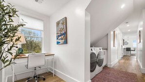 A modern kitchen with a built-in oven, a dining area with a table and chairs, and a view of the outdoors. - Warren House 2BR, Stunning Water Views Downtown (Plymouth)