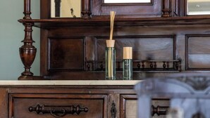 A wooden dresser with drawers and a mirror. - Harites Home – Sea View Villa A | Peaceful Island Escape with Stunning Views (Milos)