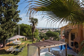 A patio with outdoor furniture, a pool, and a view of the city. - Holiday Home 'Villa Margarita' with Sea View, Wi-Fi and Air Conditioning (Denia)