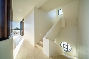 A modern interior with a staircase, a skylight, and a view of the outdoors. - Large 3 Bedroom Villa in Prime Uluwatu with Pool and Free Airport Pickup (South Kuta)