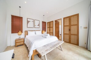 A bedroom with a bed, bedside tables, a bench, and a wardrobe. - 2BR Nunggalan Villa with Pool & Rooftop (South Kuta)