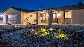 A house with a garage, a covered patio, and a mushroom garden. - Constellation of Havasu - Views, Pool, Spa (Lake Havasu City)