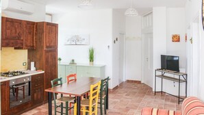 A compact living space with a kitchen, dining area, and seating area.