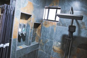 A bathroom with a shower, a towel rack, and a soap dispenser. - Cozy Loft studio with views of Downtown Tijuana (Tijuana)