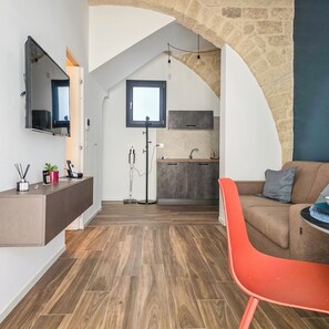 A modern living space with a kitchen, a dining area, and a cozy seating area.