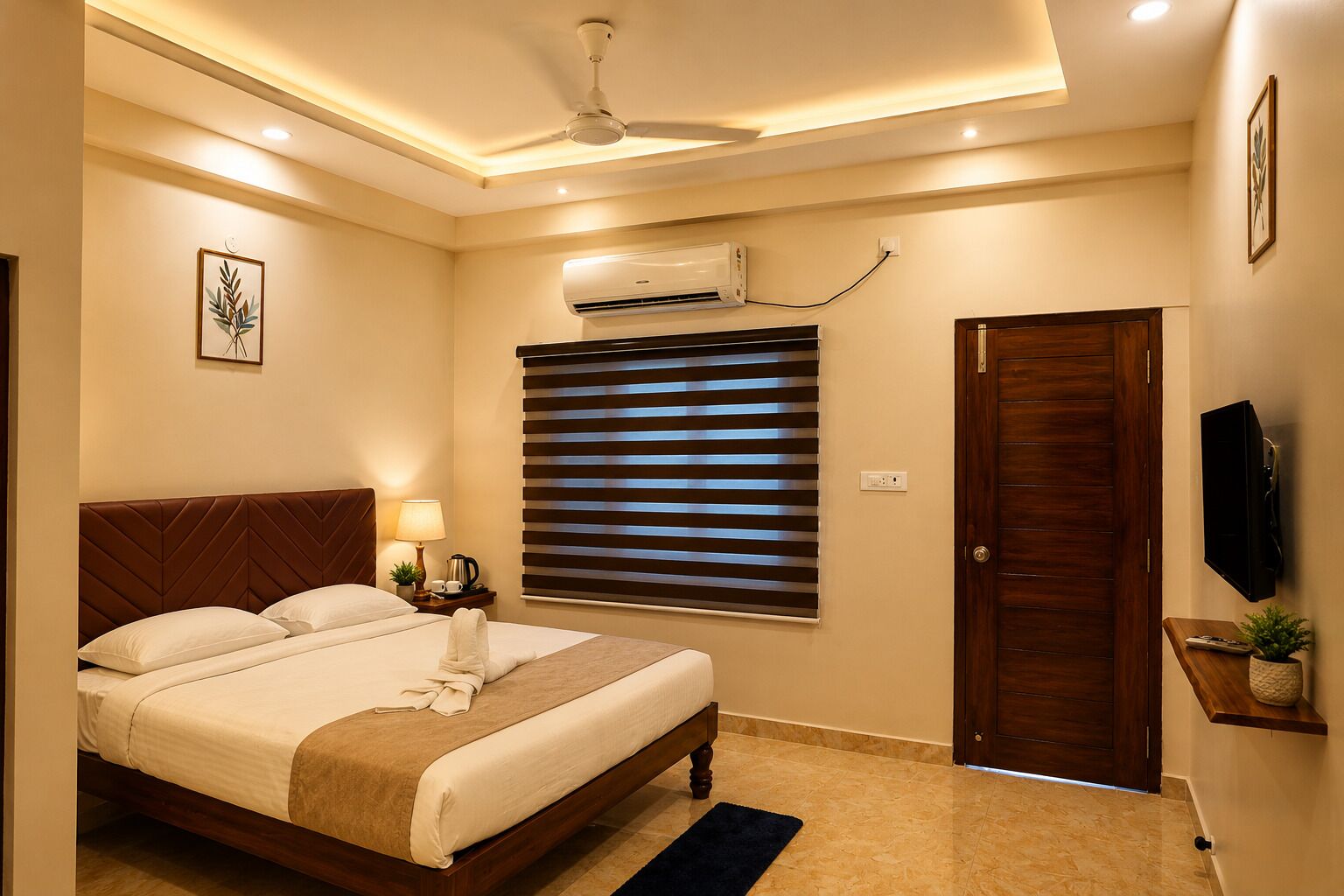 A hotel room with a bed, a ceiling fan, an air conditioning unit, a TV, a door, and a window with blinds.