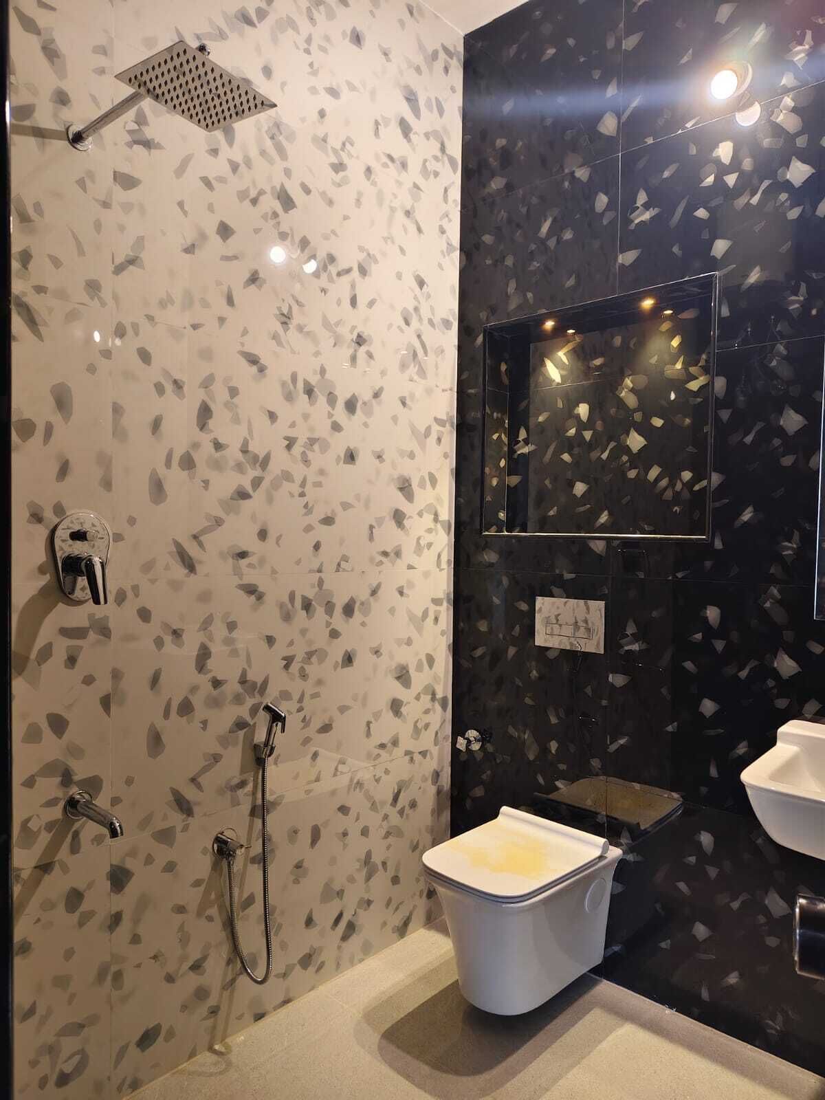 A bathroom with a shower, toilet, and sink.