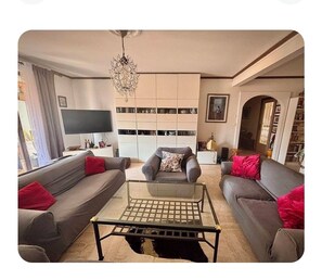 A modern living room with a sofa, armchair, and a glass coffee table. - At the gates of Cannes: Apartment 100m2 and terrace, center, Croisette on foot (Le Cannet)