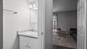 A bathroom with a sink, mirror, and towel rack. - Comfortable  2BR space near shops and dining (Riverdale)